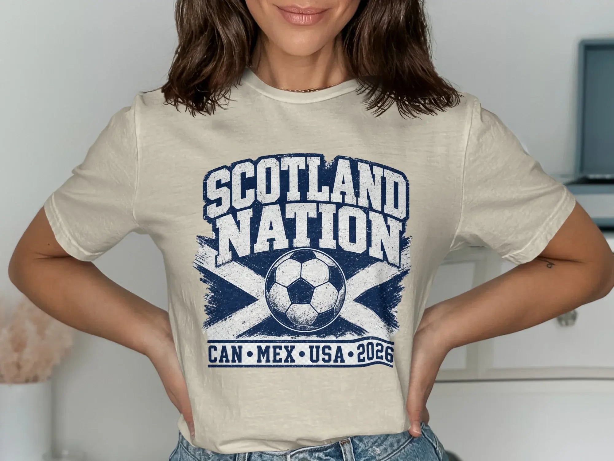 Cream t-shirt with "SCOTLAND NATION" and soccer ball above "CAN MEX USA 2026".