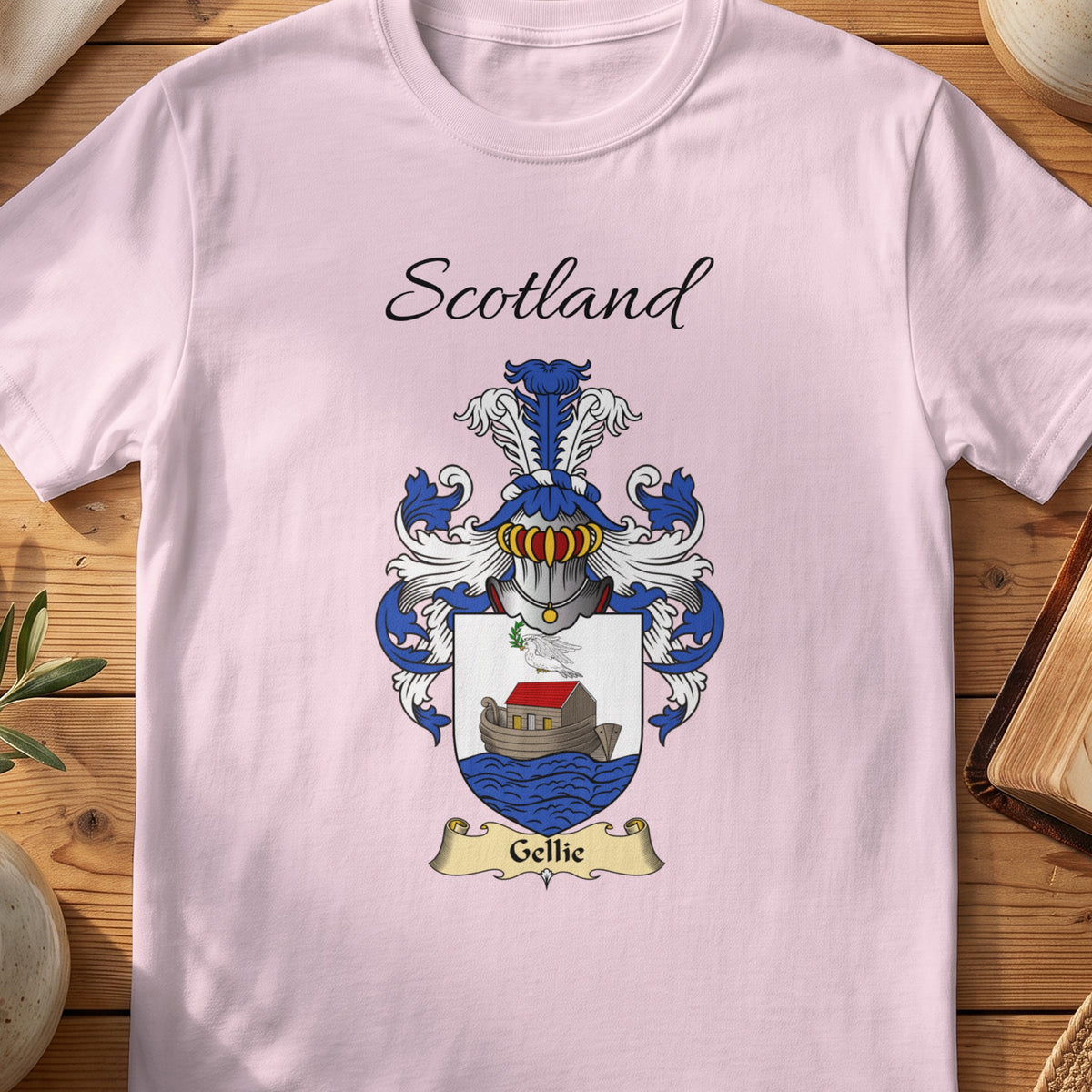 Light Pink Gellie Scottish family shield T-shirt featuring a boat on blue waves beneath a pale sky