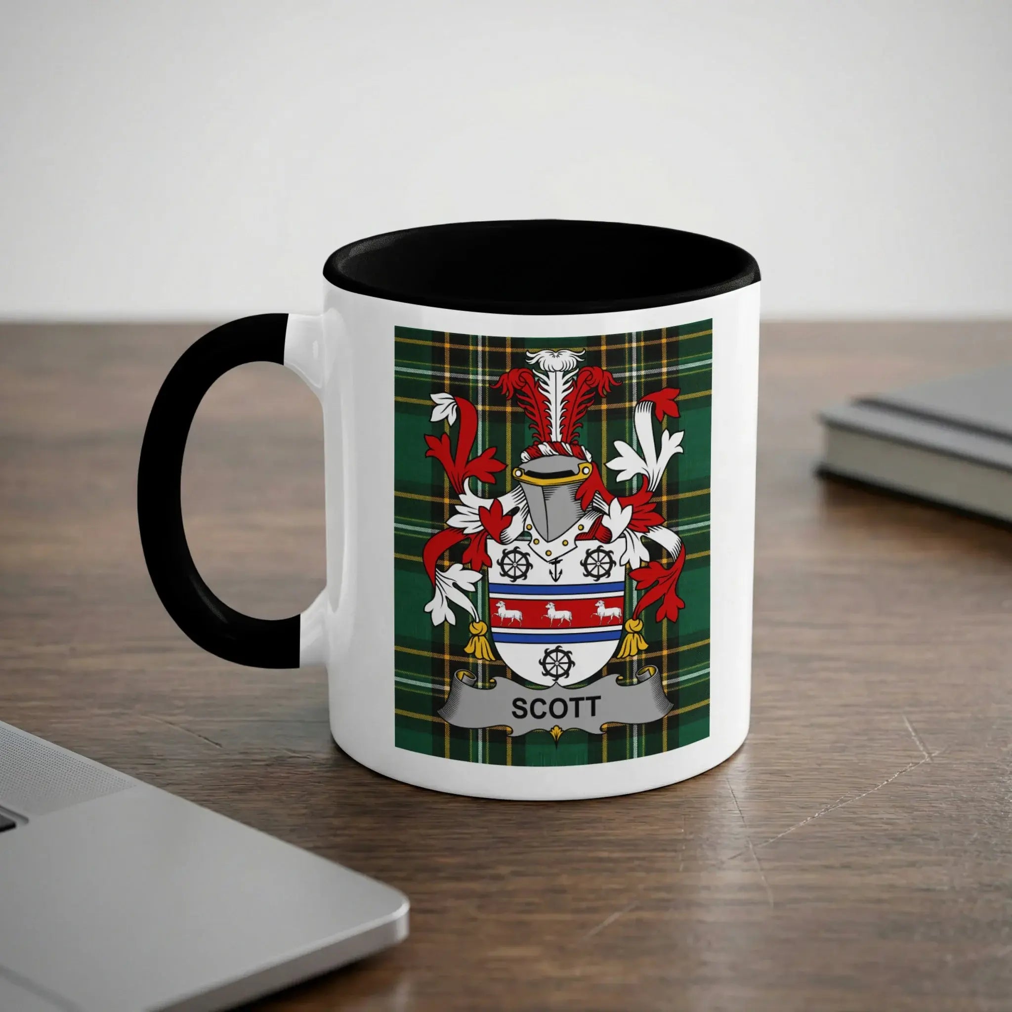 White mug with black rim featuring the Scott family crest and tartan pattern.