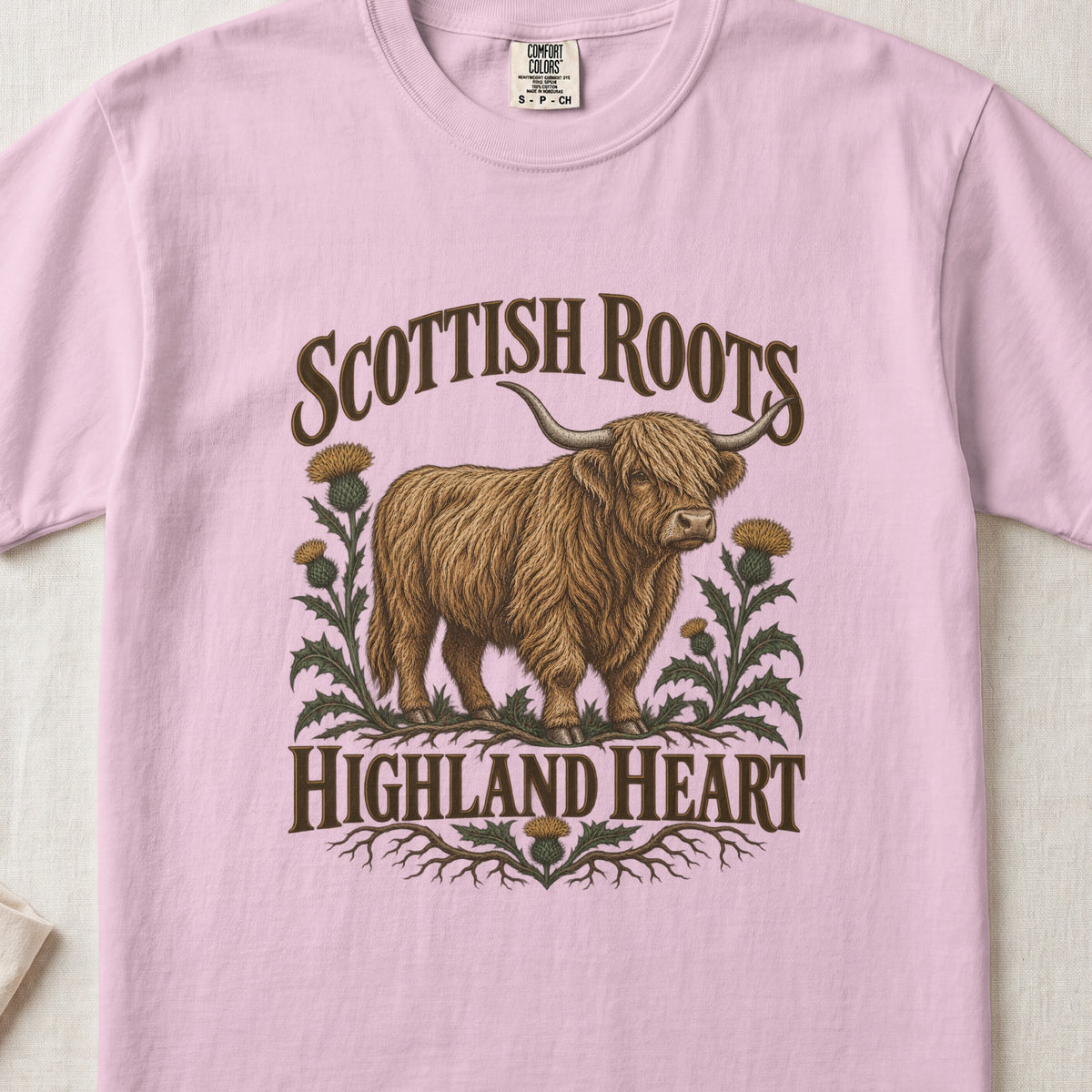 Scottish Roots, Highland Heart Highland cow design on a Blossom Comfort Colors 1717 T-shirt, flat lay