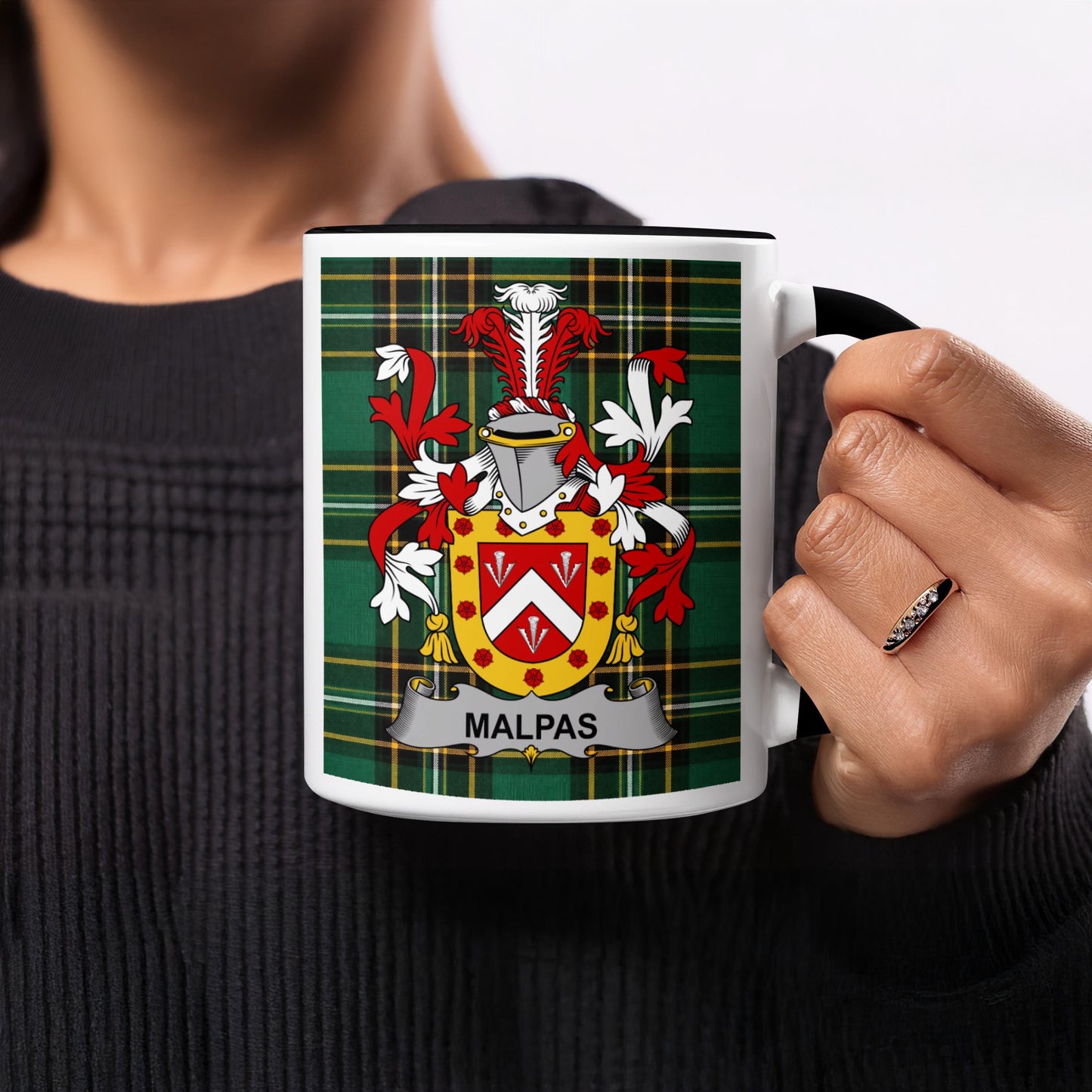 White mug with Malpas family crest on green plaid background.