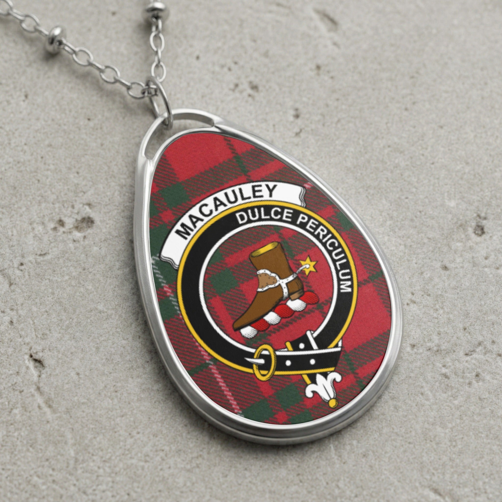Oval pendant necklace with tartan design and "MACAULEY DULCE PERICULUM" inscription.