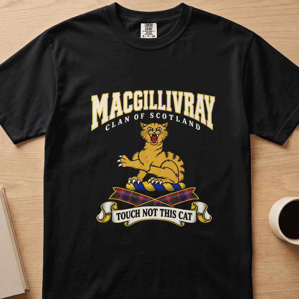 MacGillivray clan crest with gold striped cat on a black Comfort Colors T-shirt, front view