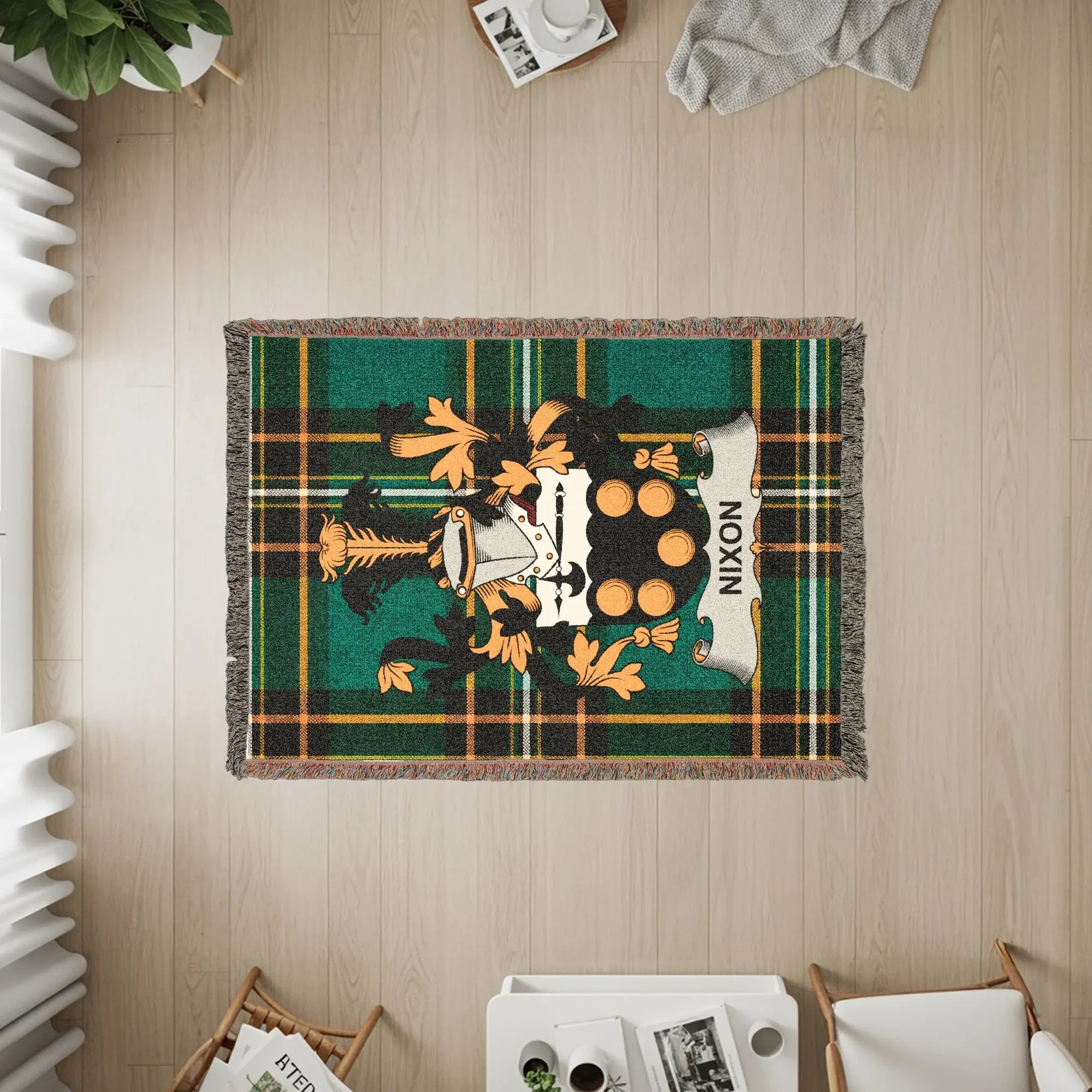 Woven blanket with Nixon family crest on green tartan plaid.