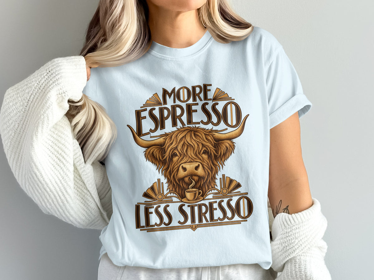 Model wearing the More Espresso, Less Stresso Highland cow Comfort Colors T-shirt in Chambray