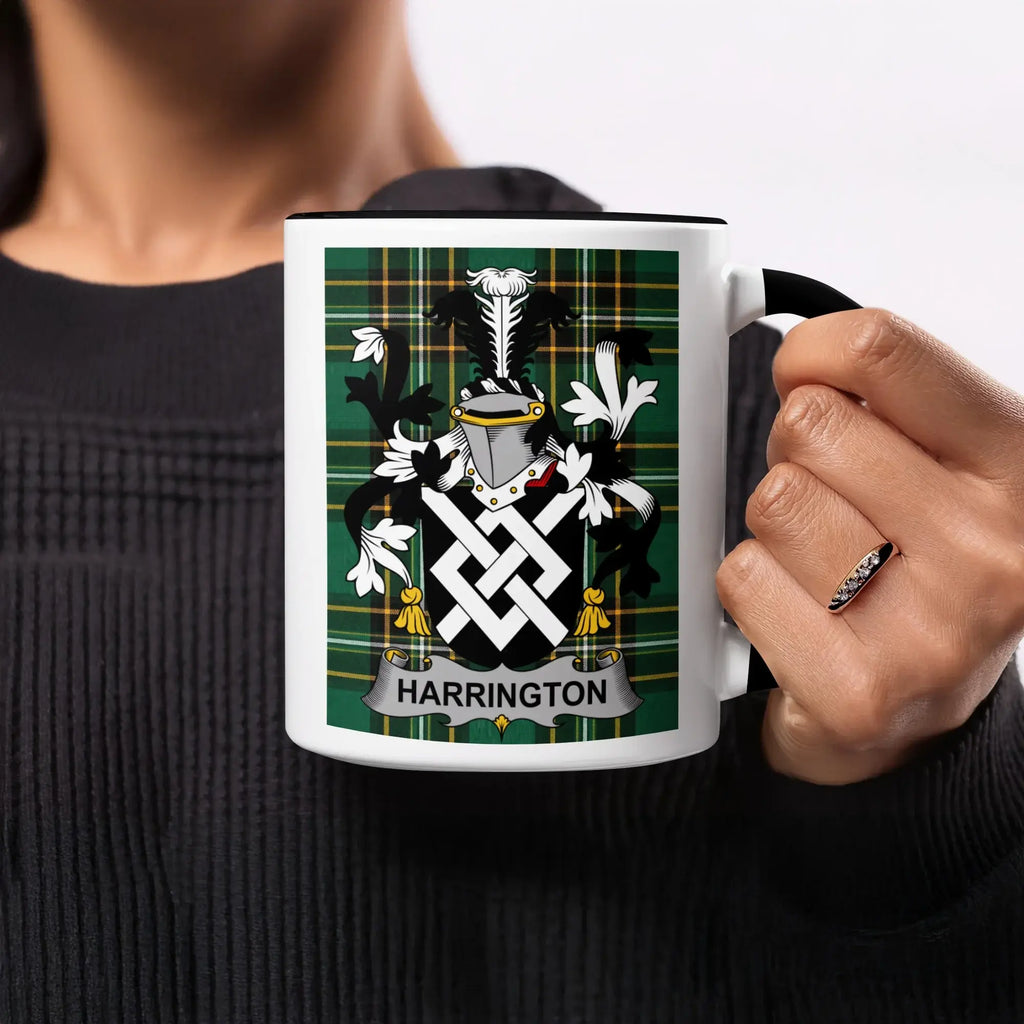 White mug with black rim featuring the Harrington family crest on a green tartan background.