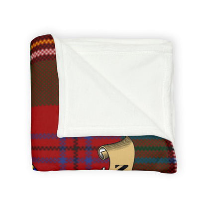 Red tartan blanket with blue and yellow accents folded neatly.