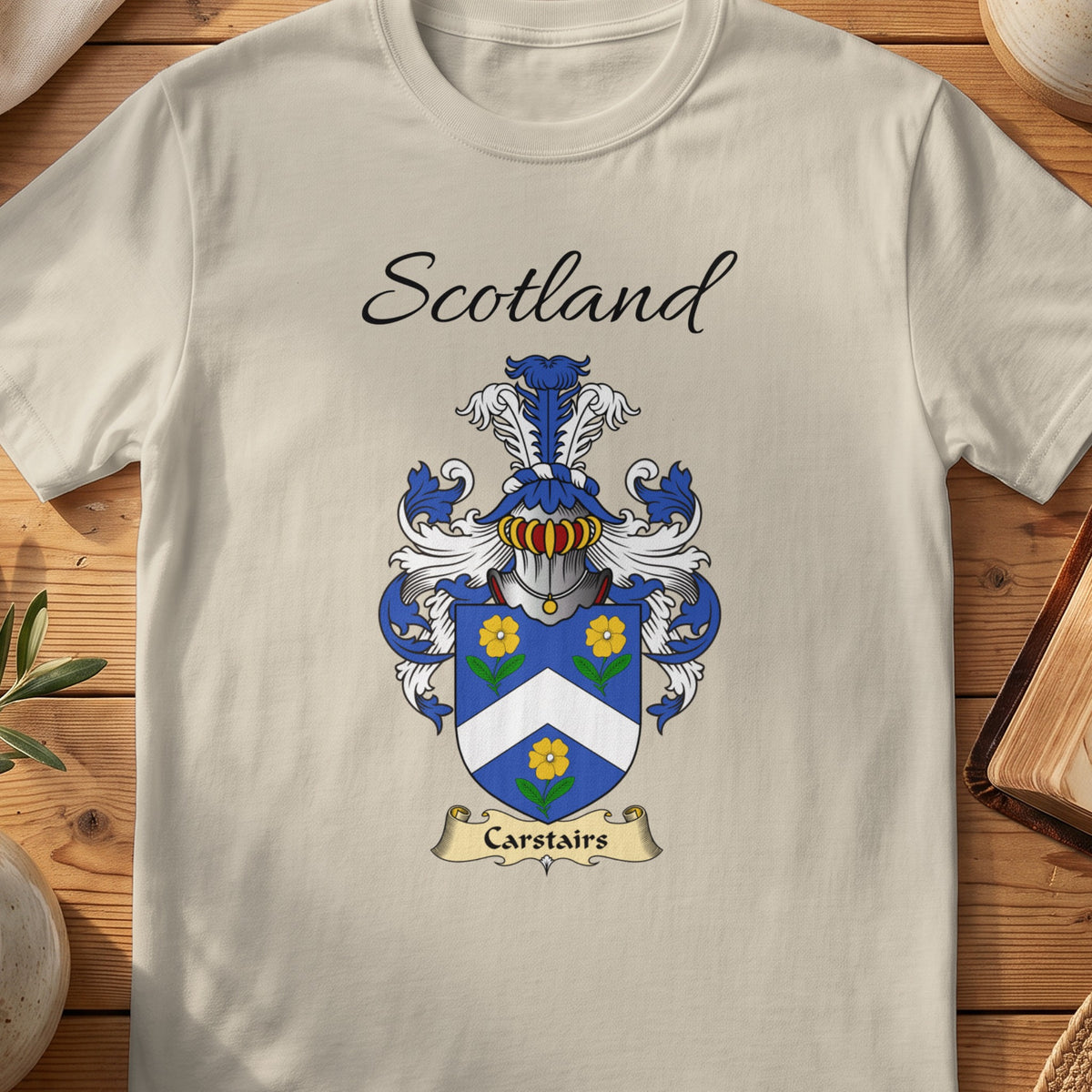 Sand Carstairs Scottish family shield T-shirt featuring a white chevron between gold flowers on blue