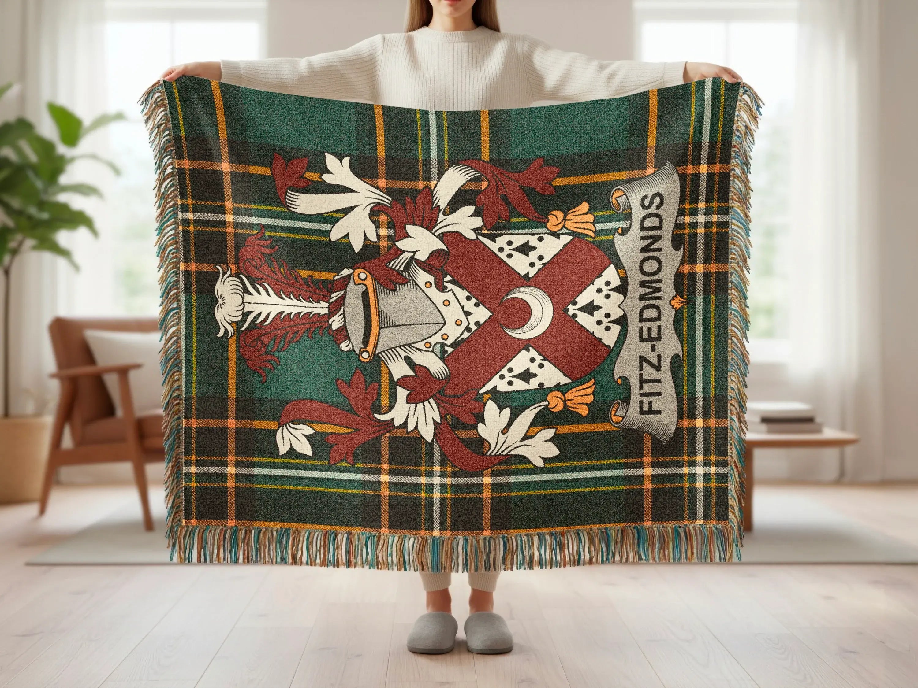Fitz-Edmonds tartan blanket with crest held by person.