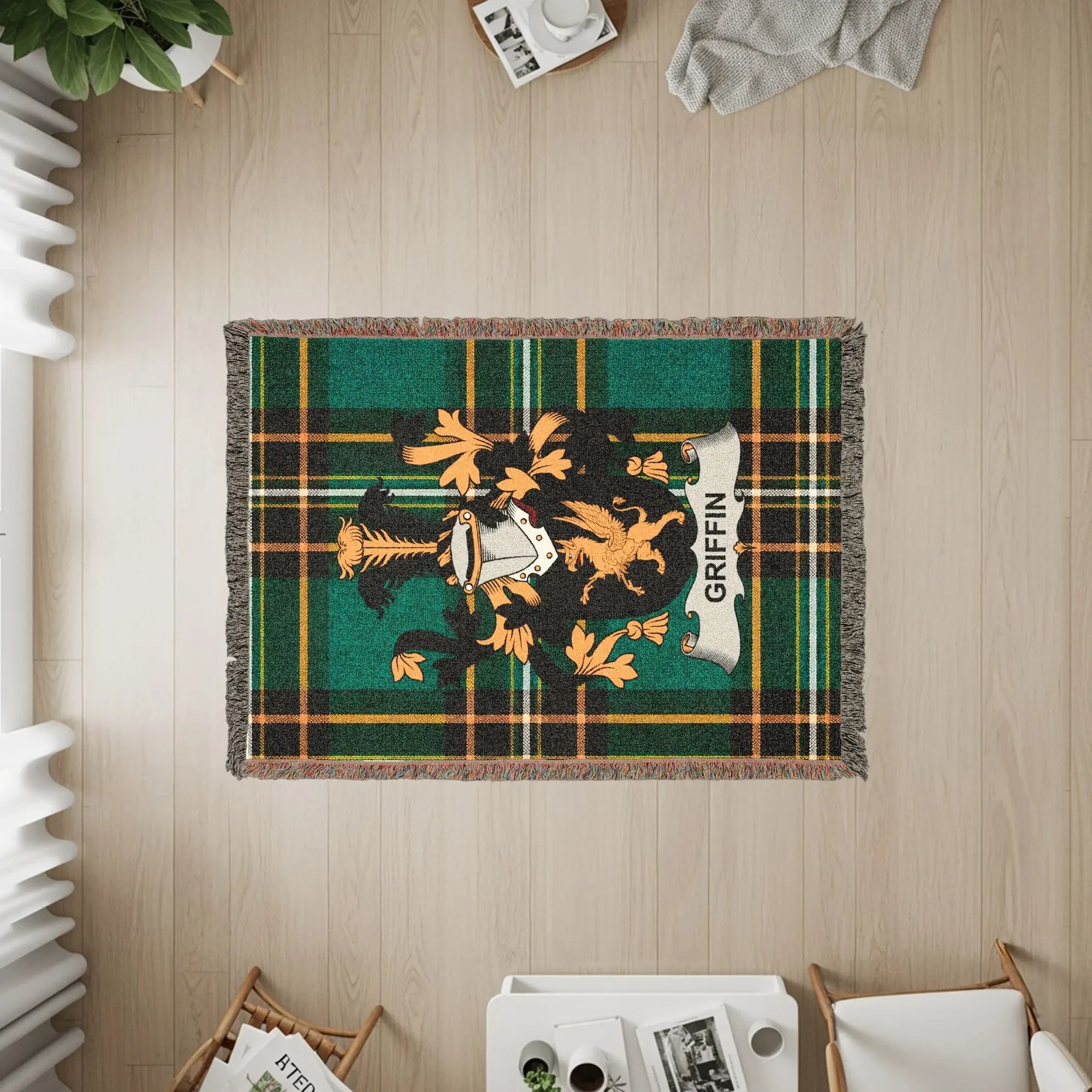 Green plaid throw blanket with a coat of arms featuring a griffin.