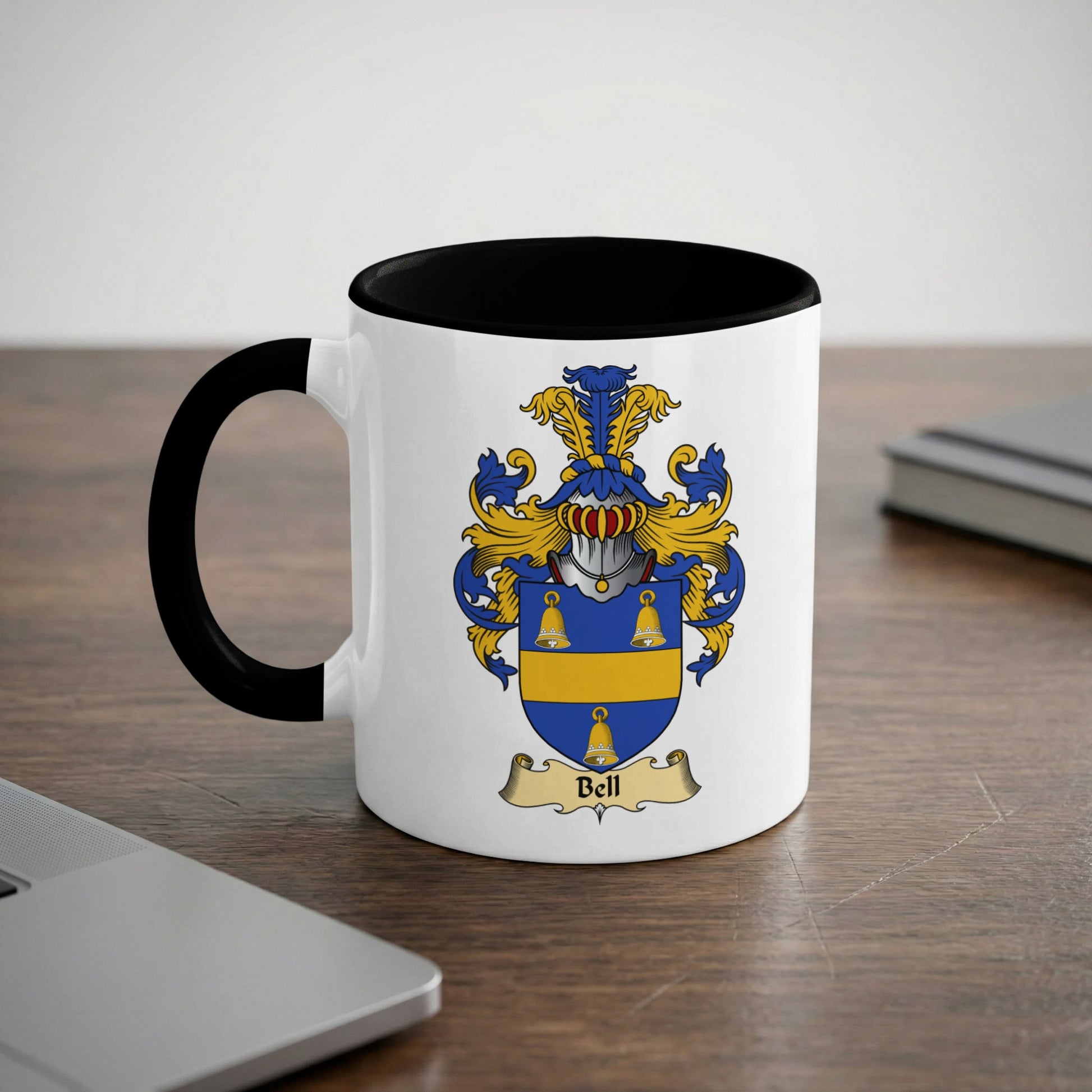 White mug with black rim and handle, featuring a coat of arms with the name "Bell".