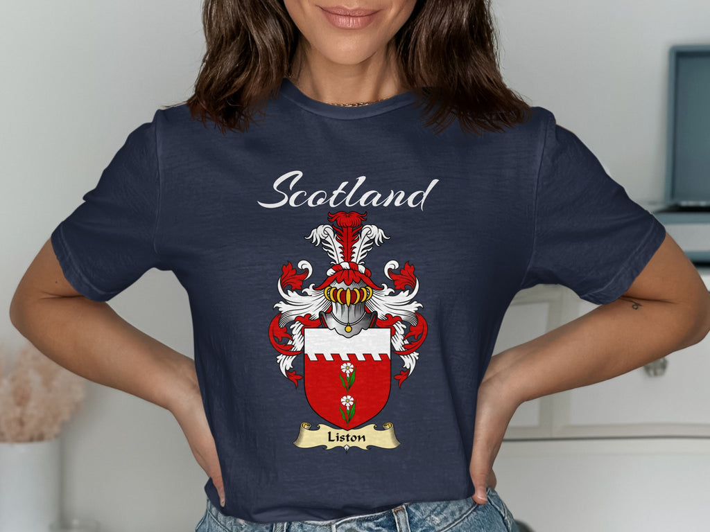 Model wearing a navy Liston T-shirt featuring a red shield with a white top band and green motif