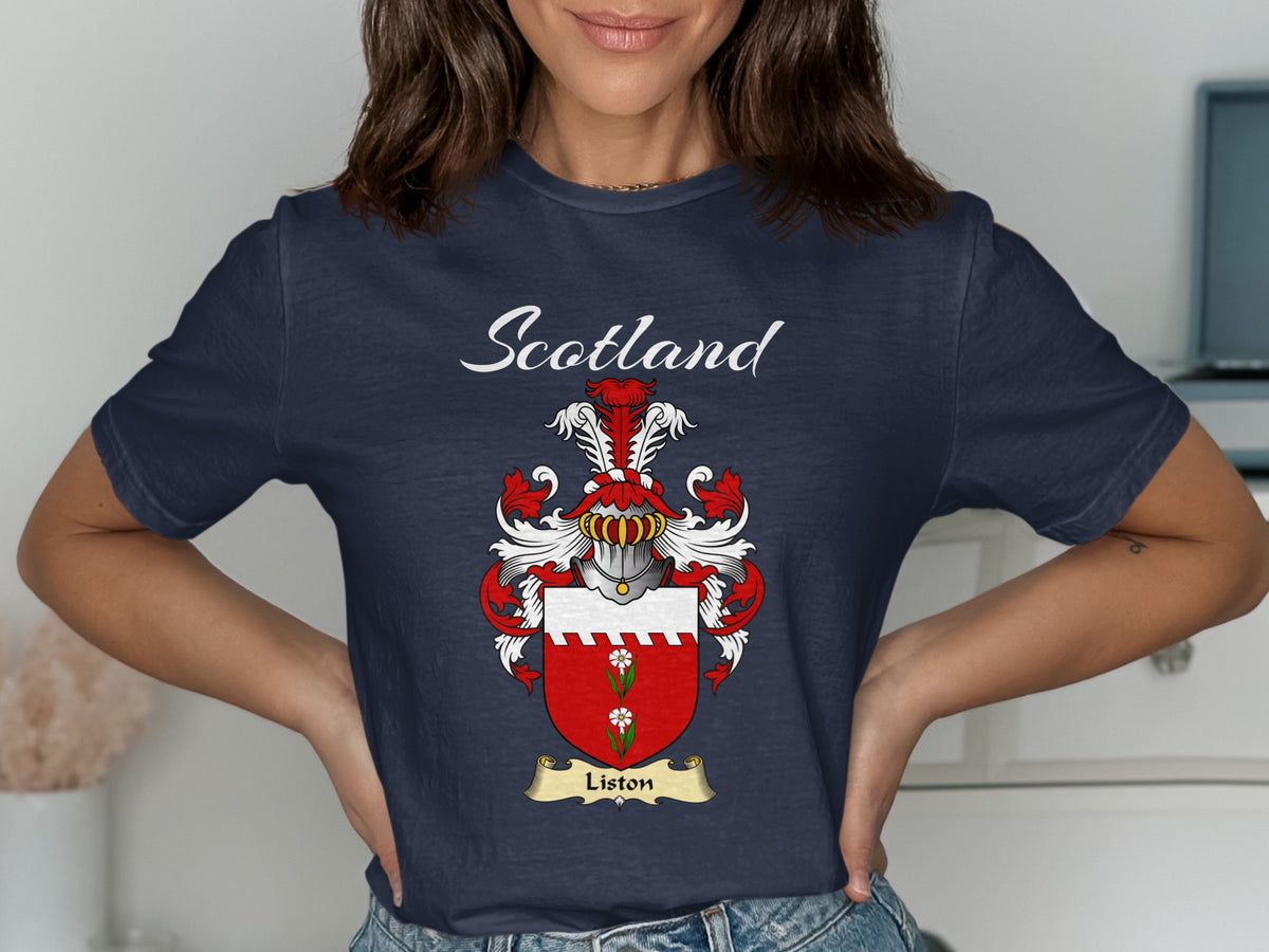Model wearing a navy Liston T-shirt featuring a red shield with a white top band and green motif