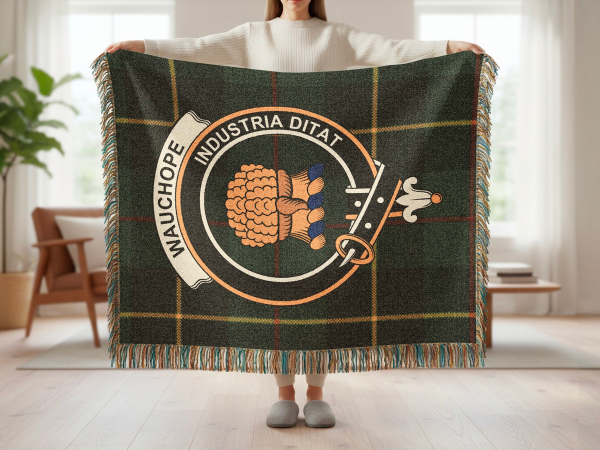 Person holding the Wauchope woven blanket to show the full design, tartan background and fringe