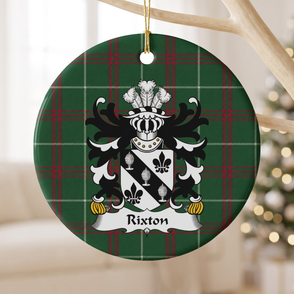 Rixton ceramic ornament with a black diagonal band with three silver covered cups between black fleurs-de-lis on Welsh National Tartan, hanging beside a window.