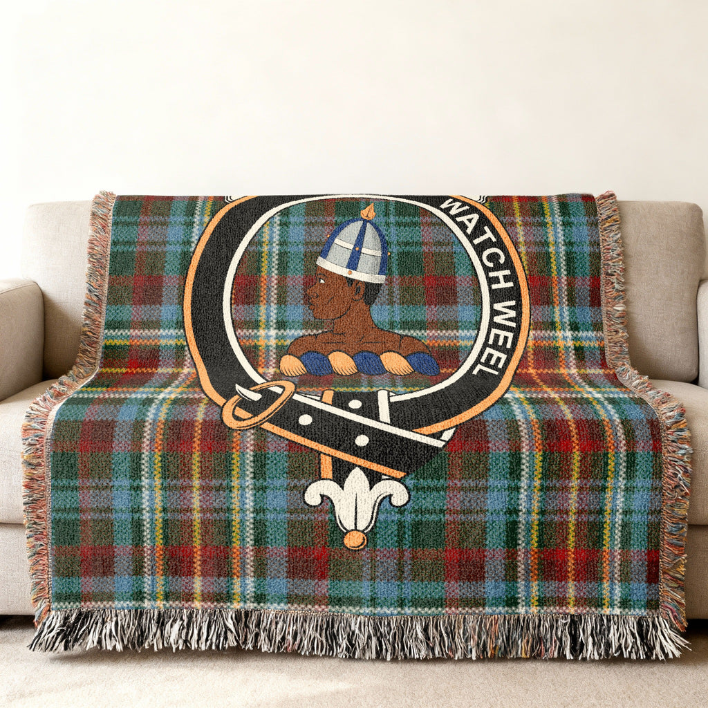Close view of the Haliburton woven blanket draped over a sofa, showing the crest and fringed edges