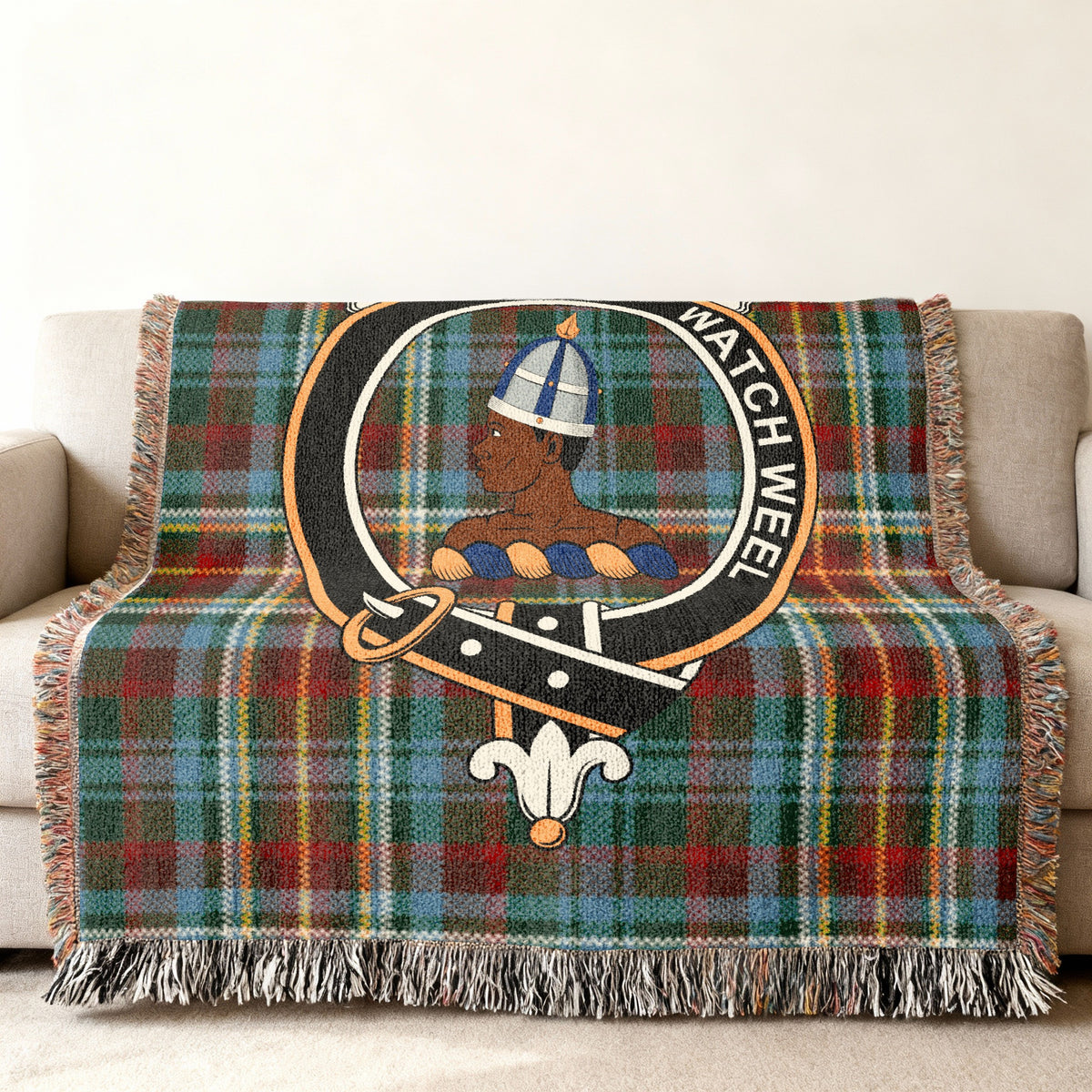 Close view of the Haliburton woven blanket draped over a sofa, showing the crest and fringed edges