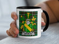 White mug with black handle displaying the GRUMLEY family crest on a green tartan background.