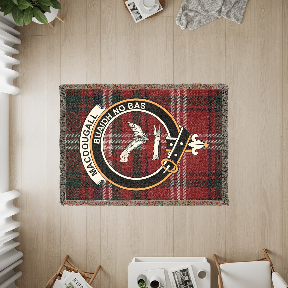 MacDougall woven blanket displayed on a wall, featuring the crest badge and tartan background