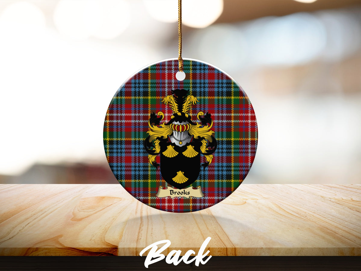 Round Brooks Scottish clan ornament with family crest on a Caledonia tartan background