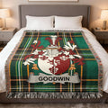 Plaid throw blanket with a coat of arms and the name GOODWIN.