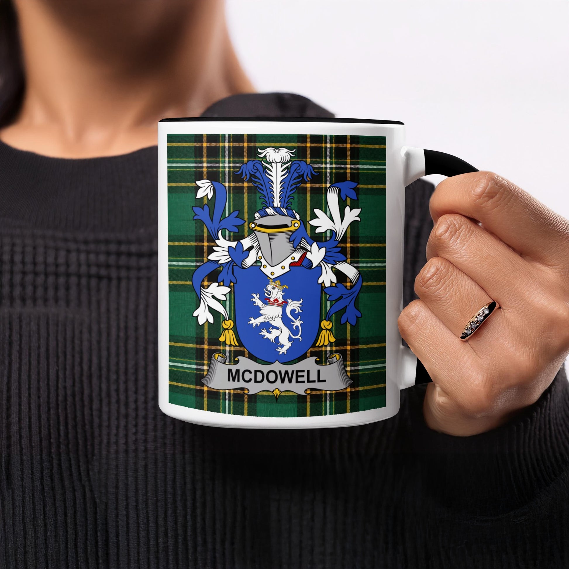 White mug with black handle featuring McDowell family crest on plaid background.