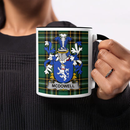 White mug with black handle featuring McDowell family crest on plaid background.