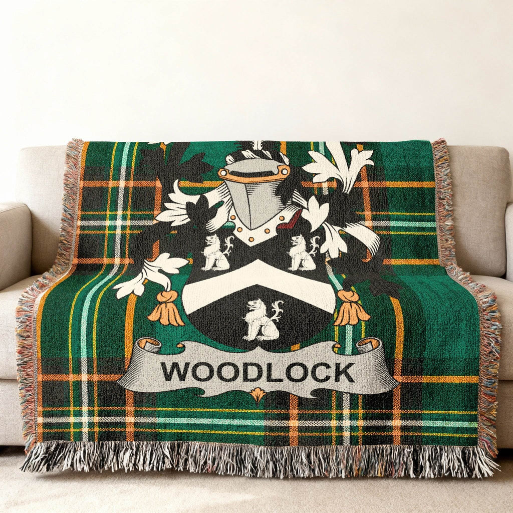 Green plaid throw blanket with Woodlock family crest displayed.