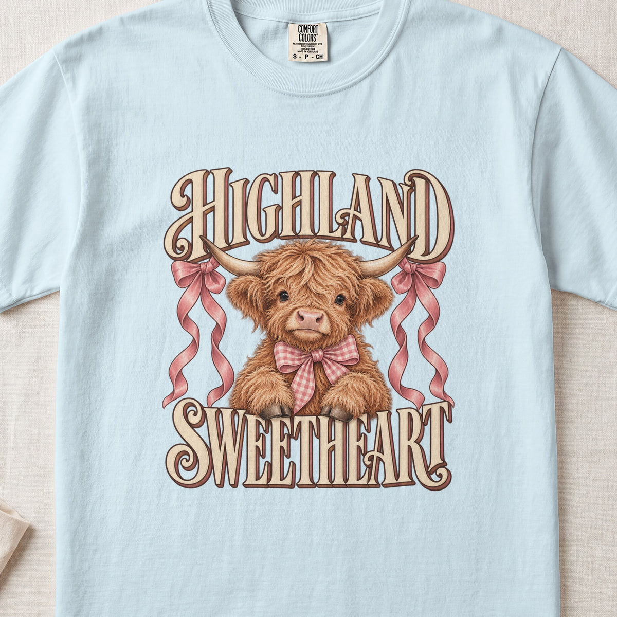Highland Sweetheart Highland cow design on a Chambray Comfort Colors 1717 T-shirt, flat lay