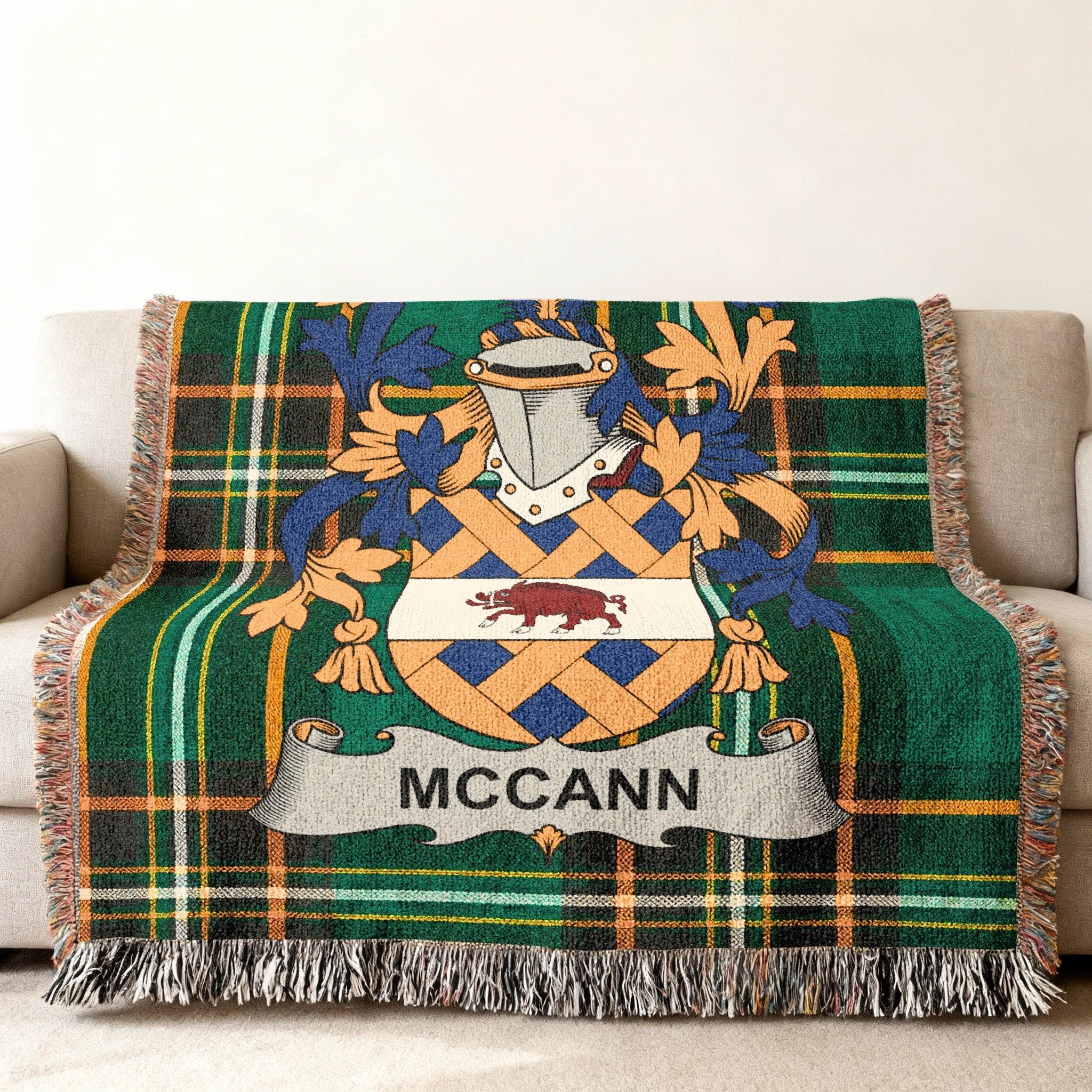 Green tartan blanket with McCann family crest and name.