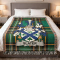 Tartan blanket with Slater family crest on a bed.