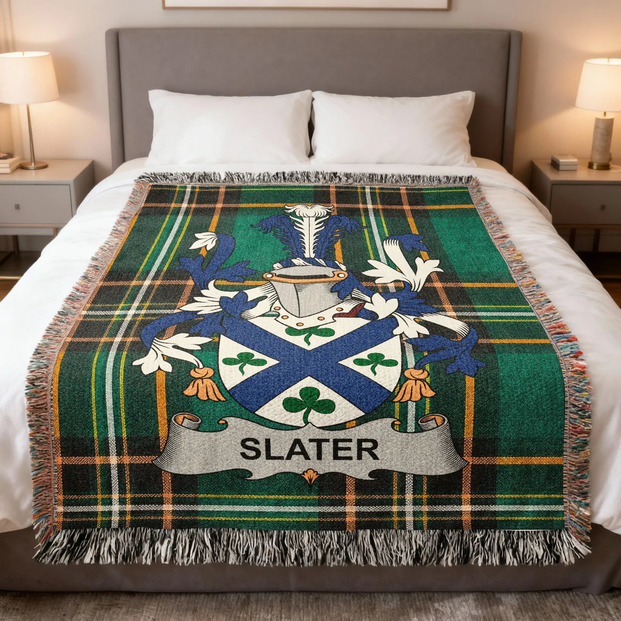 Tartan blanket with Slater family crest on a bed.
