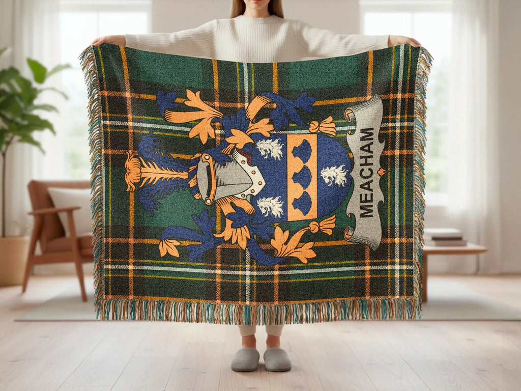 Tartan blanket with Meacham coat of arms held by person.