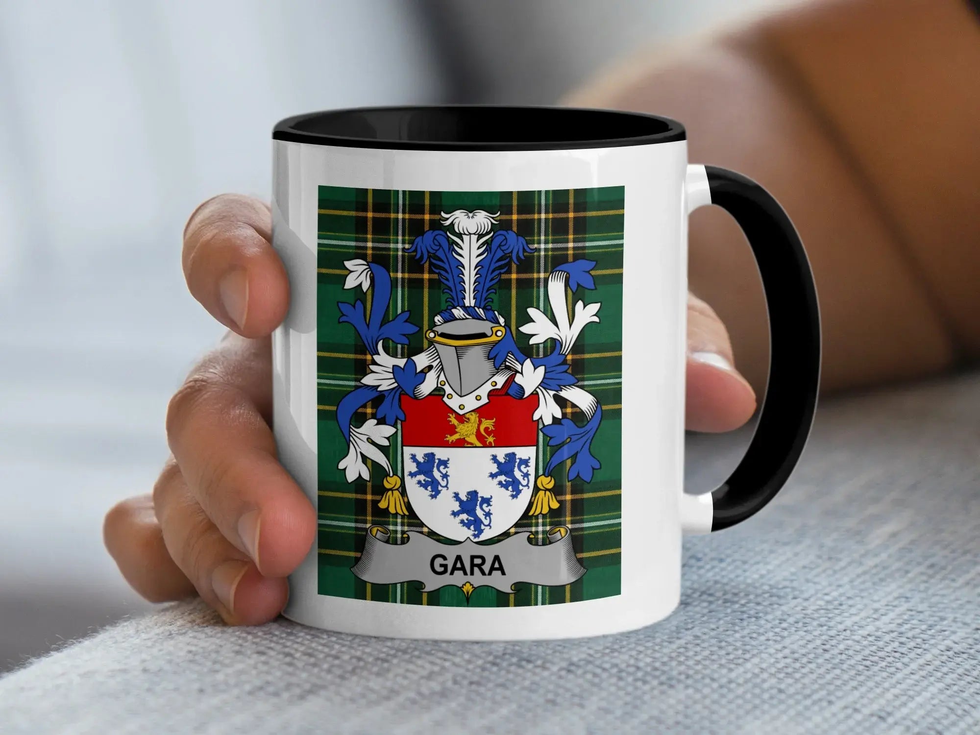 White mug with black handle featuring a family crest with plaid background and the name "Gara".