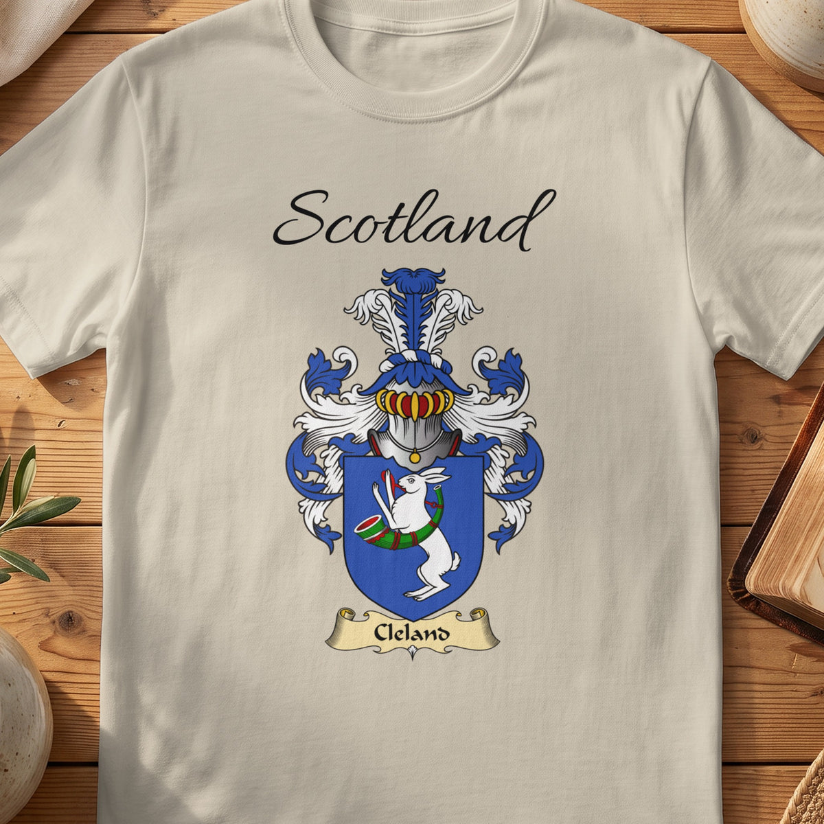 Sand Cleland Scottish family shield T-shirt featuring a white hare with a green hunting horn