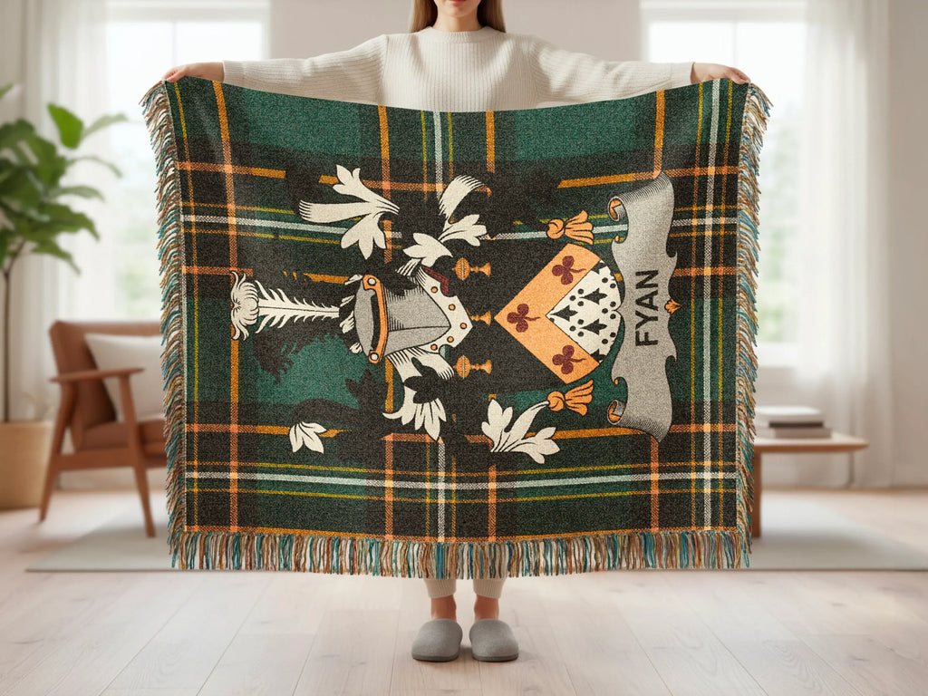 Green tartan blanket with a coat of arms and "FYAN" text.
