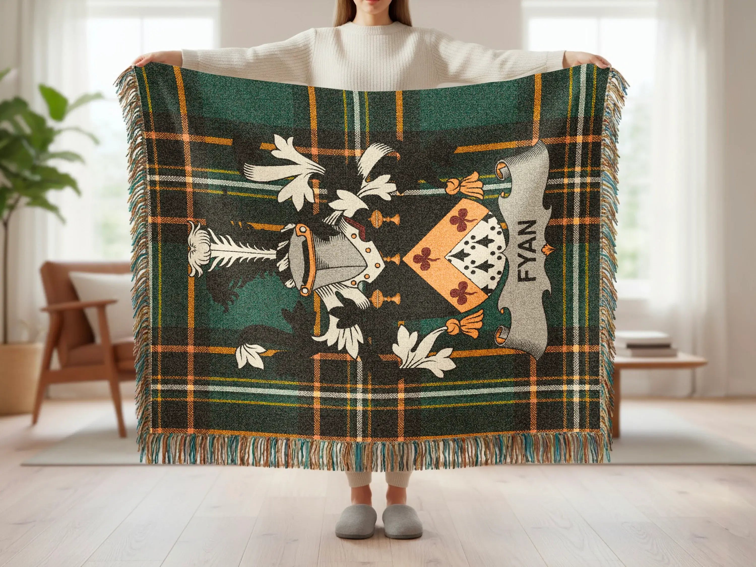 Green tartan blanket with a coat of arms and "FYAN" text.