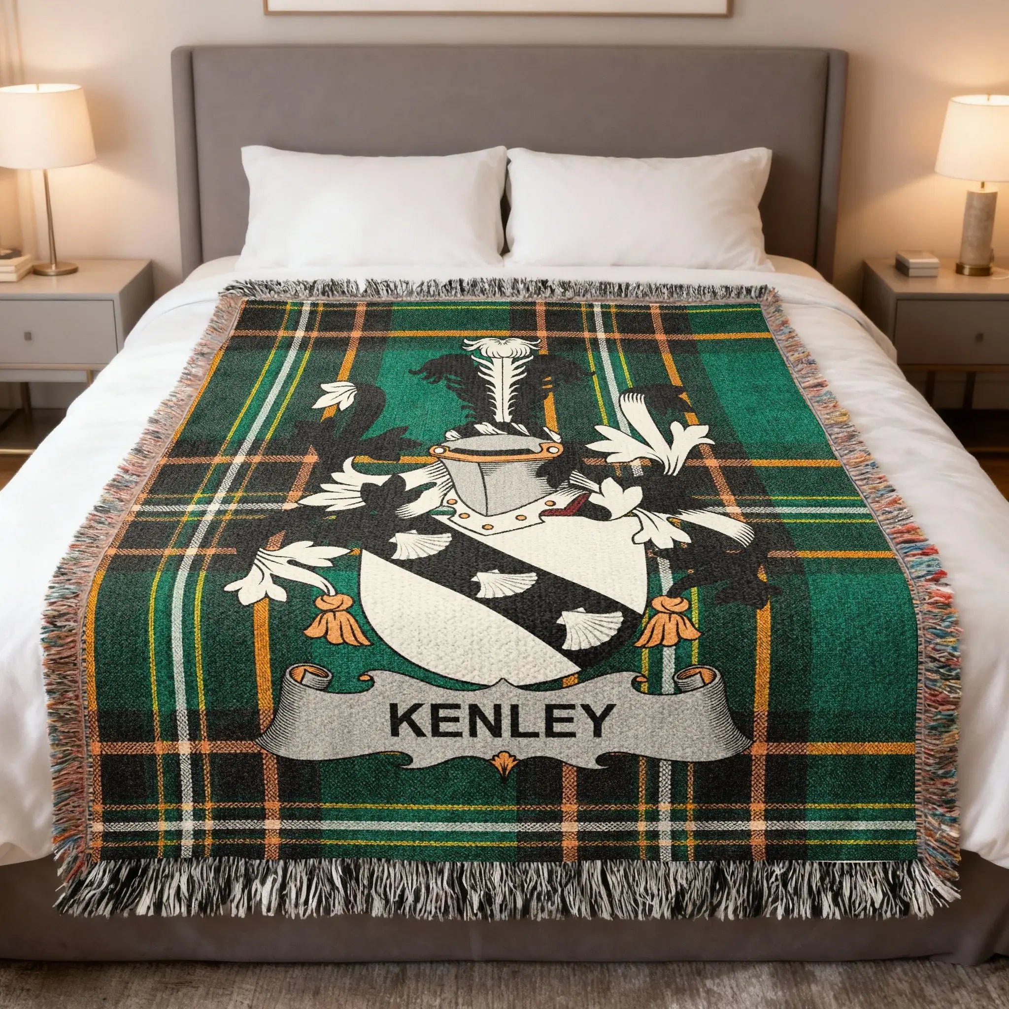 Green tartan blanket with KENLEY family crest centered on a bed.