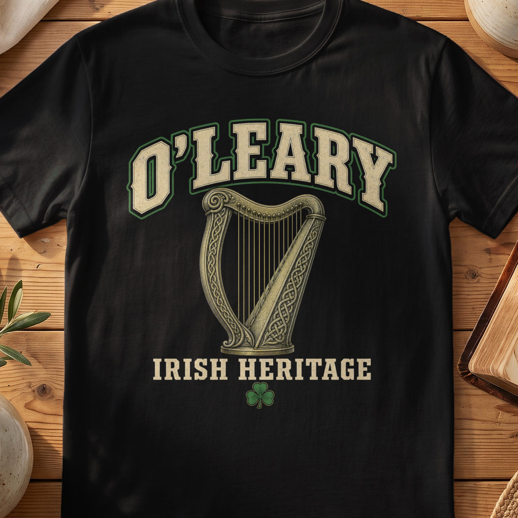 O'Leary Irish harp T-shirt in Black, with cream surname lettering, a gold-toned harp, green shamrock and “Irish Heritage” text.