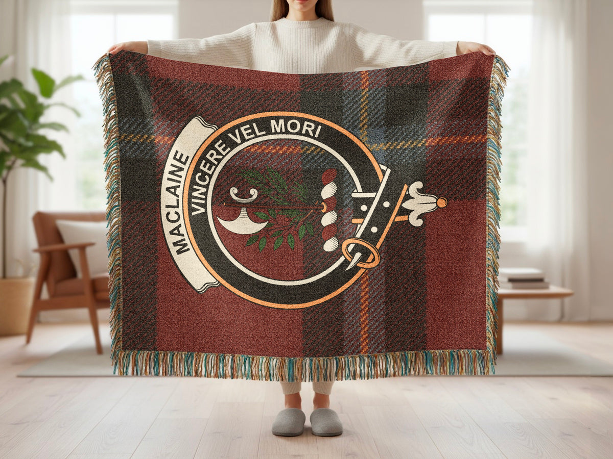 Person holding the MacLaine of Lochbuie woven blanket to show the full design, tartan background and fringe