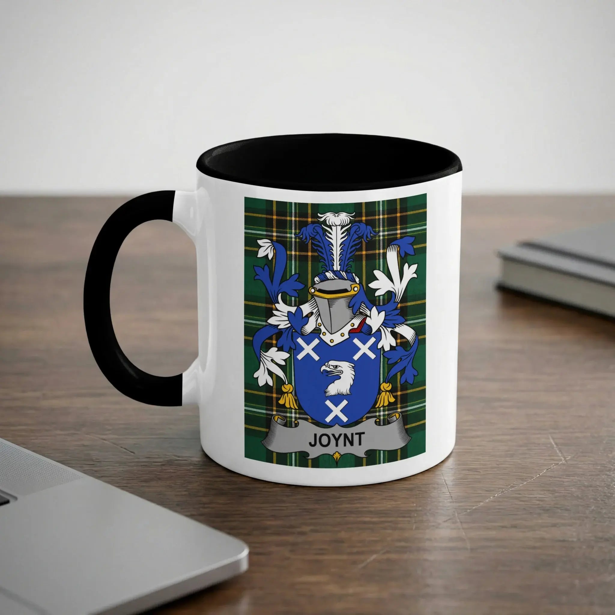 White mug with black rim displaying the Joynt family crest on a checkered background.