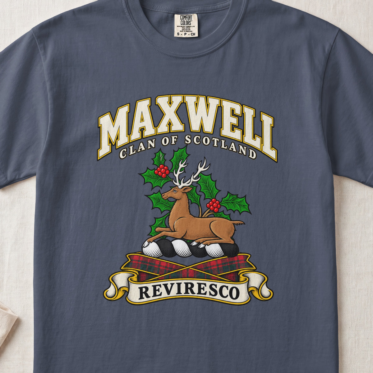 Maxwell Scottish clan T-shirt in Midnight, front view with a resting stag surrounded by holly leaves and red berries and motto banner.