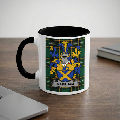 White mug with black rim featuring the Markham coat of arms on a plaid background.