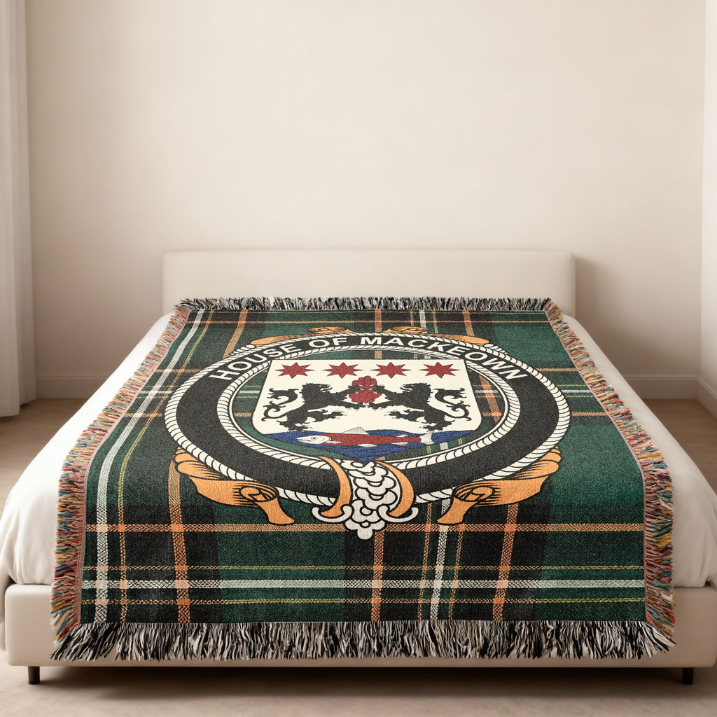 McKeown family crest emblem woven blanket displayed on a bed