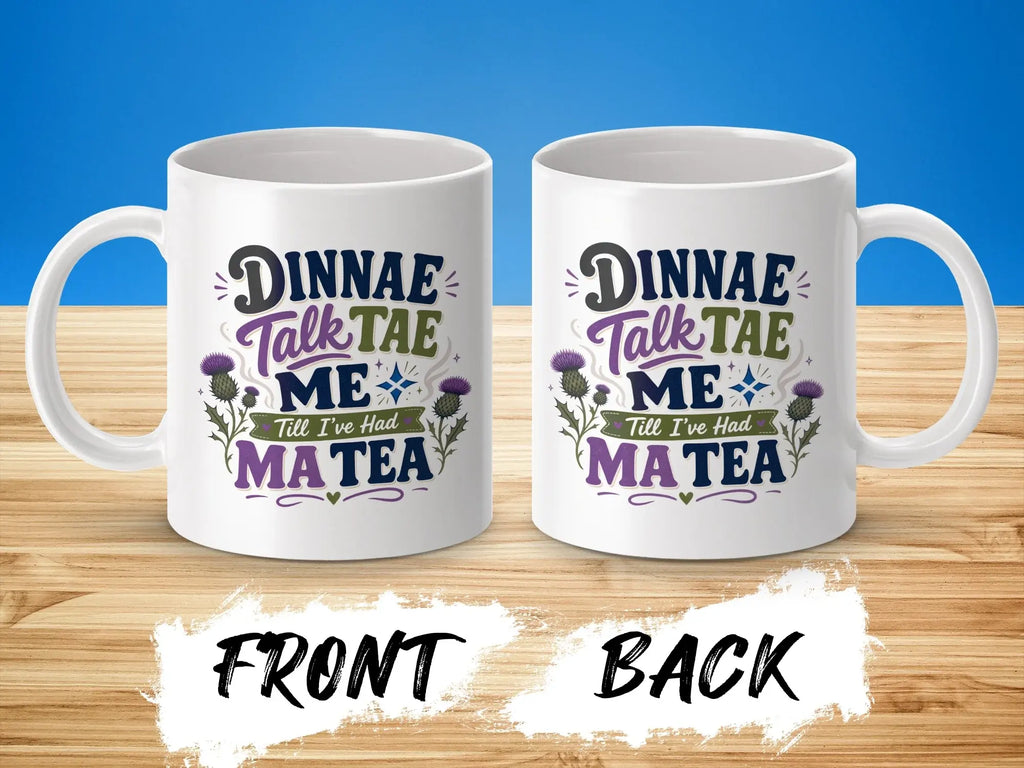 White mug with Scottish phrase "Dinnae talk tae me till I've had ma tea" and thistles.