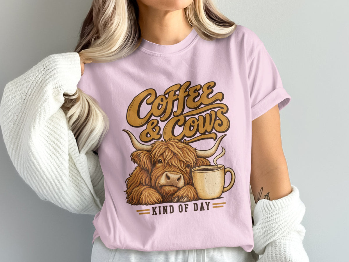 Model wearing the Coffee & Cows Kind of Day Highland cow Comfort Colors T-shirt in Blossom