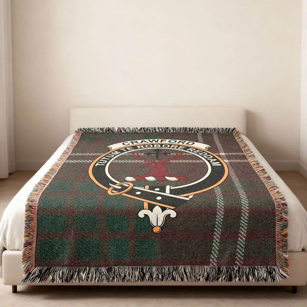 Crawford clan crest tartan woven blanket — stag crest at centre, fringe edge visible