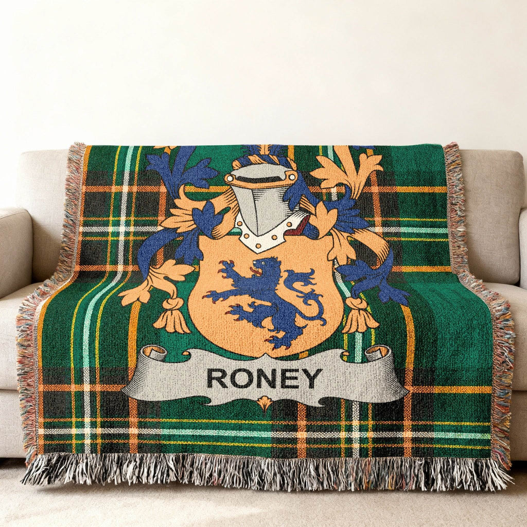 Woven throw blanket with Roney family crest on green plaid background.