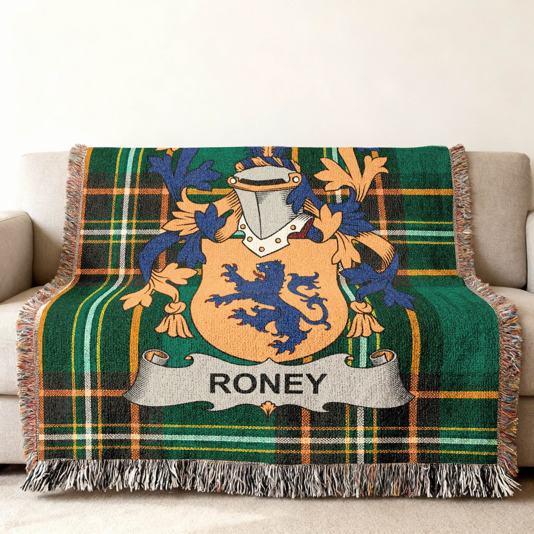 Woven throw blanket with Roney family crest on green plaid background.