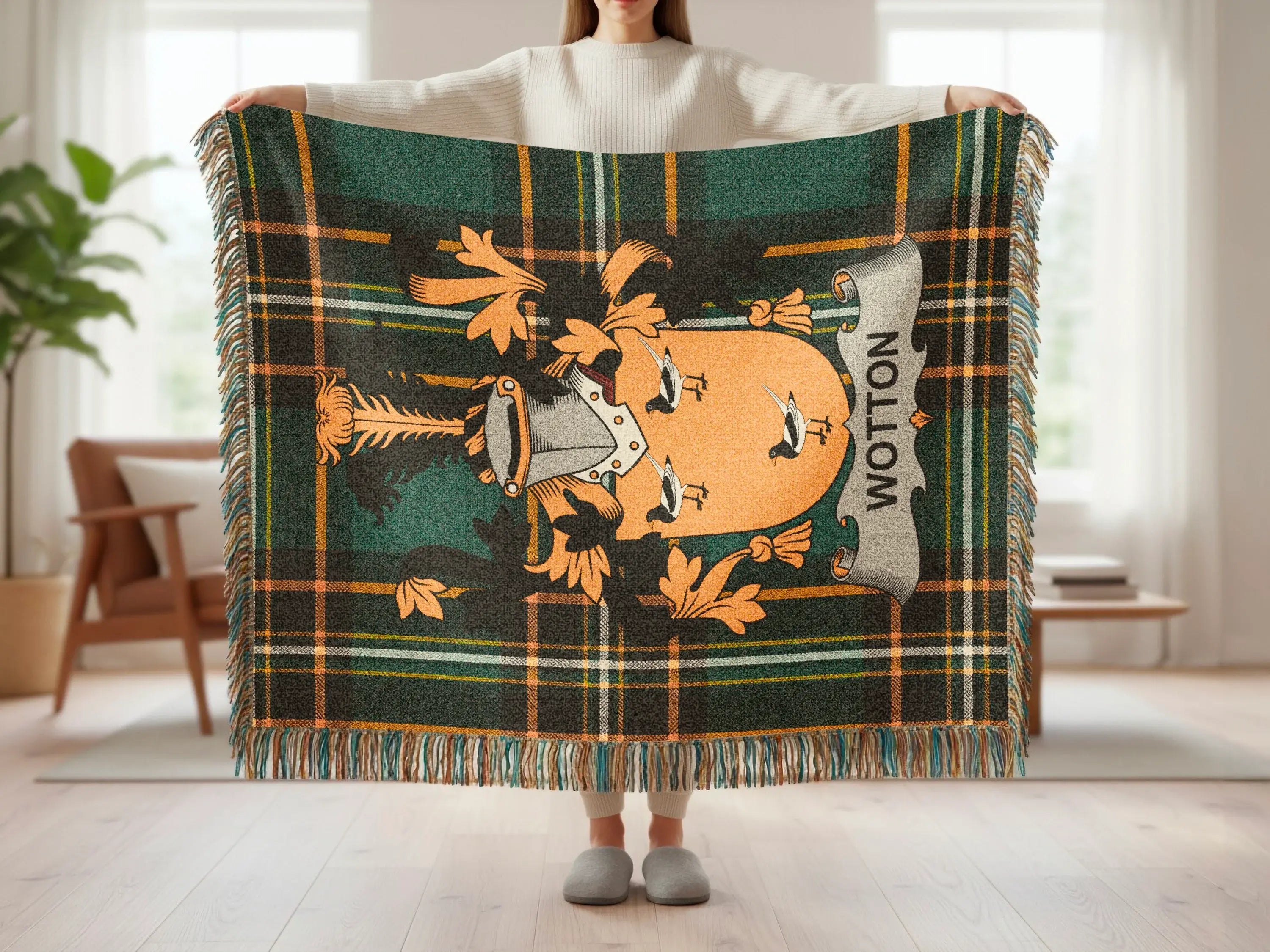 Tartan blanket with Wotton crest and fringed edges, held by a person.